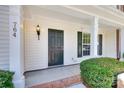 Inviting front porch with classic details, exterior lighting, and a well-kept landscape at 764 Atherton Way, Rock Hill, SC 29730