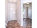 Bright entryway featuring modern wood flooring and a neutral color scheme, leading to the rest of the home at 8655 Meadowmont View Dr, Charlotte, NC 28269