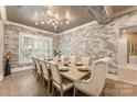 A dining room with a farmhouse table and large brick accent wall at 10007 Hillspring Dr, Huntersville, NC 28078