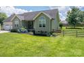 Beautiful home with a well-maintained lawn and a classic wooden fence adding charm to the property at 104 Nottingham Dr, Maiden, NC 28650