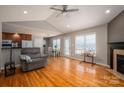 Bright living room featuring wood floors, fireplace, ceiling fan and views of the kitchen and dining area at 104 Nottingham Dr, Maiden, NC 28650