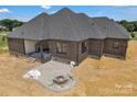 A luxurious patio with a built-in fire pit, a seating area, and stylish stone paving at 106 Kelly Marie Ct, Kings Mountain, NC 28086