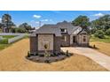 An inviting home featuring brick and stone accents, a well-manicured front yard, and an attached two-car garage at 106 Kelly Marie Ct, Kings Mountain, NC 28086