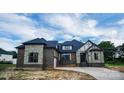 Stylish home exterior showcasing a mix of stone and brick, a gray roof, and well-placed windows at 106 Kelly Marie Ct, Kings Mountain, NC 28086
