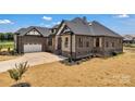 A beautiful home featuring brick and stone accents, with a two-car garage and tastefully landscaped yard at 106 Kelly Marie Ct, Kings Mountain, NC 28086