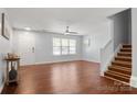 Bright living room with hardwood floors, ample natural light, and staircase to the second floor at 11023 Kinston Ridge Pl, Charlotte, NC 28273
