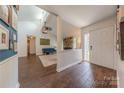 Bright, open-concept living room featuring a stone fireplace and hardwood floors at 11834 Carmel Lakes Dr, Charlotte, NC 28226