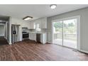 Bright kitchen with stainless steel appliances, white cabinets, and a sliding door to the outdoor deck at 120 Tower Dr, Statesville, NC 28677