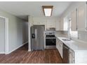 Modern kitchen with white countertops, stainless steel appliances, and ample cabinet space at 120 Tower Dr, Statesville, NC 28677