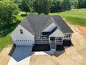 Beautiful new construction home with a welcoming front porch and attached two-car garage at 133 Harbourtown Dr, Kings Mountain, NC 28086