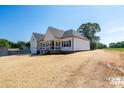 Beautiful home with a white exterior, inviting front porch, and well-manicured lawn at 133 Harbourtown Dr, Kings Mountain, NC 28086