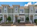 Charming townhouse exterior with light green siding, white trim, symmetrical shrubbery, and a welcoming entrance at 17431 Tuscany Ln, Cornelius, NC 28031