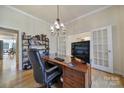 Spacious office with large wooden desk, hardwood floors, shelving, and french doors at 2000 Taney Way, Indian Land, SC 29707