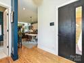 Bright foyer leading to a dining area showcasing hardwood floors and an open concept design at 2553 Elkwood Cir, Charlotte, NC 28205