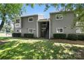Exterior view of a two-story apartment building with gray siding and well-maintained landscaping at 3020 Heathstead Pl # A, Charlotte, NC 28210