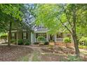 Charming home featuring a covered front porch, neutral siding, and well-manicured landscaping at 3020 Waxhaw Crossing Dr, Waxhaw, NC 28173