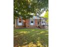 A lovely brick home with a well-kept lawn, complemented by stylish blue shutters and a welcoming entrance at 3774 Seaman Dr, Charlotte, NC 28217