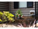 Close-up of a cozy seating area on the front porch, accented with flowers and greenery at 407 Sweetgum Dr # B, Fort Mill, SC 29715