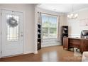 Bright home office with hardwood floors, a large window, and a modern desk and shelving at 4116 Tory Path Rd, Waxhaw, NC 28173