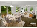 Bright, staged living and dining area featuring neutral tones and large windows for natural light at 424 Mallard Dr, Pineville, NC 28134