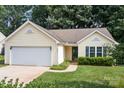 Inviting single-story home with green shutters has an attached garage and walkway at 5221 Javitz Rd, Charlotte, NC 28216