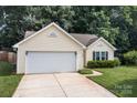 Charming single-story home has a two-car garage and manicured front lawn at 5221 Javitz Rd, Charlotte, NC 28216
