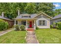 Charming home with inviting curb appeal, a red front door, and lush green lawn at 524 W Horah St, Salisbury, NC 28144