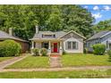 Charming home with inviting curb appeal, a red front door, and lush green lawn at 524 W Horah St, Salisbury, NC 28144