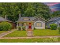 Charming home with inviting curb appeal, a red front door, and lush green lawn at 524 W Horah St, Salisbury, NC 28144