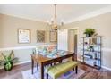 Elegant dining room featuring a wooden table, chandelier, and stylish decor at 5610 Monticello Nw Dr, Concord, NC 28027
