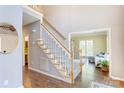 Bright foyer with hardwood flooring, staircase, and view of the living room at 5610 Monticello Nw Dr, Concord, NC 28027