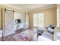 Comfortable office with sliding barn doors, built-in desk, and ample natural light at 5610 Monticello Nw Dr, Concord, NC 28027