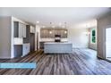 Open-concept kitchen with gray cabinets, a center island, and modern appliances at 608 Banter Ln # 31, Cramerton, NC 28032