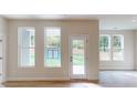 Open-concept living room with abundant natural light through windows and door at 608 Banter Ln # 31, Cramerton, NC 28032