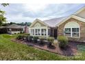 Inviting home exterior with stone accents, a cozy porch, and neatly trimmed shrubs enhancing curb appeal at 6811 Ledgestone Pl, Charlotte, NC 28227