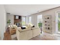 Bright living room featuring a brick fireplace and neutral furniture at 7217 Rena Mae Ln, Charlotte, NC 28227