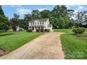 Inviting home exterior featuring a spacious front yard and long driveway at 920 Manor Dr, Kings Mountain, NC 28086