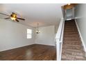 Bright living room featuring hardwood floors, fresh neutral paint, and a staircase to the upper level at 1007 Green Terra Rd, Indian Trail, NC 28079