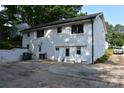 Spacious backyard featuring white brick exterior, ample parking, and exterior doors at 1038 Holmes Ave, Salisbury, NC 28144