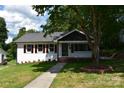 Charming one-story home with well-kept lawn, sidewalk, and mature trees at 1038 Holmes Ave, Salisbury, NC 28144