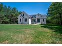 Stylish white brick home featuring a well-manicured lawn and a classic architectural design at 1062 Sage Pine Cir, Clover, SC 29710
