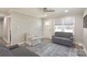 Comfortable living room featuring hardwood floors, neutral walls, ceiling fan, and bright natural light at 111 Berry St, Chester, SC 29706