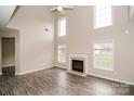 Bright living room featuring a fireplace, hardwood floors, and abundant natural light from large windows at 11305 Erwin Ridge Ave, Charlotte, NC 28213
