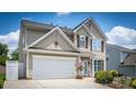 Beautiful two-story home featuring a two-car garage and a well-kept lawn at 115 Morrocroft Ln, Mooresville, NC 28117