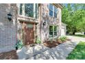 Close-up of front door with decorative glass panels and sidelights, welcoming entrance at 12004 Woodholm Ct, Tega Cay, SC 29708