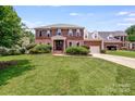 Beautiful two story brick home with lush green lawn and inviting curb appeal at 12416 Stirling Trace Ct, Charlotte, NC 28277