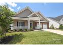 Inviting home featuring a cozy front porch and lush landscaping at 14019 Cameryn Elise Dr, Cornelius, NC 28031