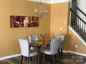 Cozy dining area with modern chandelier, glass table, and seating for four at 15005 Savannah Hall Dr # 72, Charlotte, NC 28273