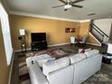 Bright living room with a neutral sectional sofa, modern lighting, and stylish decor at 15005 Savannah Hall Dr # 72, Charlotte, NC 28273