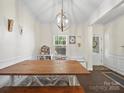 Cozy dining area featuring a rustic wood table and a stylish chandelier at 159 Autumn Mist Rd, Statesville, NC 28677